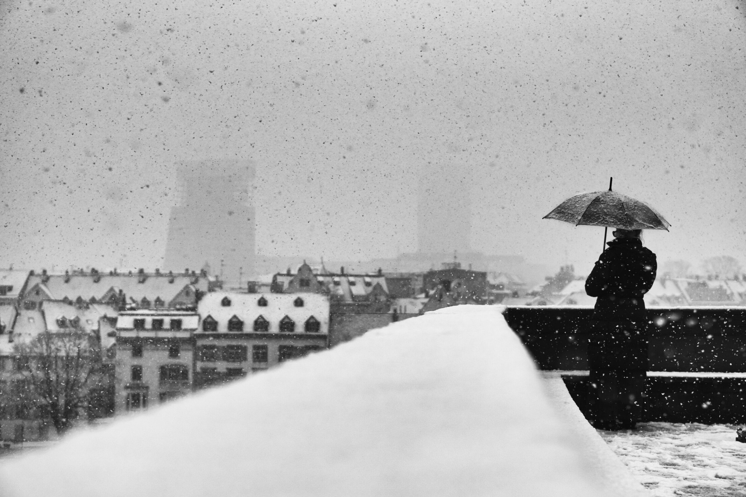 Snowfall over Basel fine art print, a black and white winter scene captured by Swiss photographer Bastian Peter (Street Fotografie)